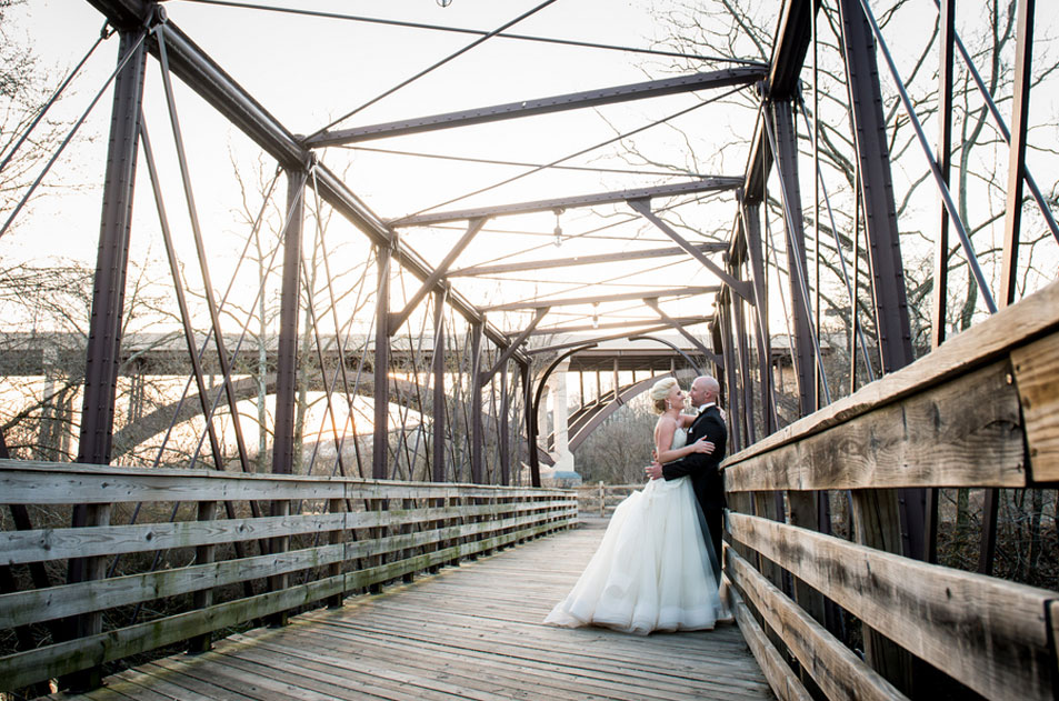 Bride and groom on the bridge at Phoenixville Foundry during the day