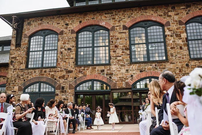 Flower girls adorning the walkway at the Chang Wedding at Phoenixville Foundry